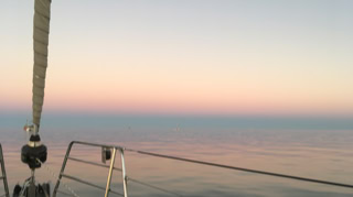 Beautiful Dusk with calm water  on  Sailing Yacht Curlew Escape, available for private yacht charters on Moreton Bay, Brisbane.