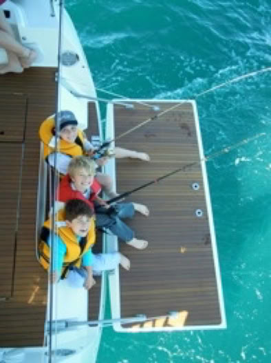 Boys fishing off the yacht