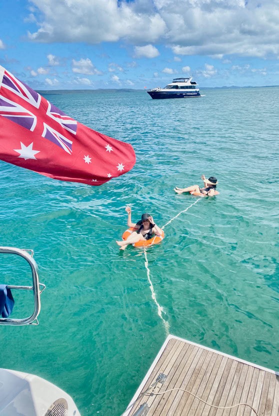 Birthday girl and friend floating in the life rings at Peel Island.